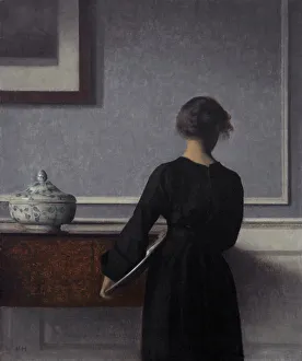 Innenausicht mit jungen Frau von hinten. Künstler: Hammershøi, Vilhelm (1864-1916)